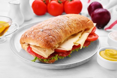 Delicious sandwich with cheese, salami, tomato on white wooden table, closeup