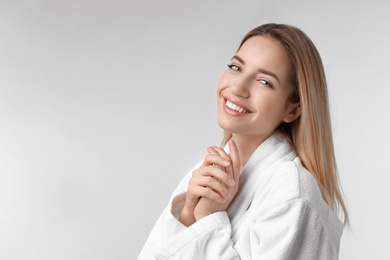 Photo of Beautiful young woman with silky skin on light background