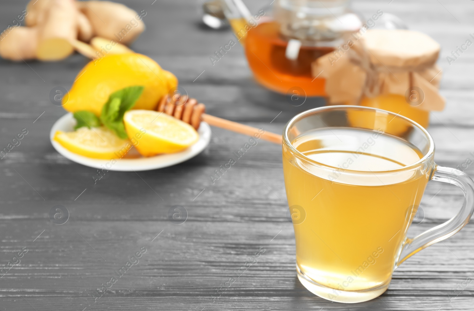 Photo of Cup with hot tea for cold on wooden table