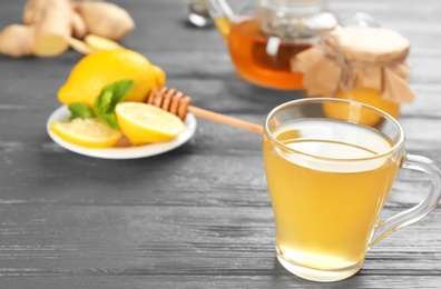 Cup with hot tea for cold on wooden table