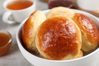 Photo of Tasty scones prepared on soda water on grey marble table, closeup