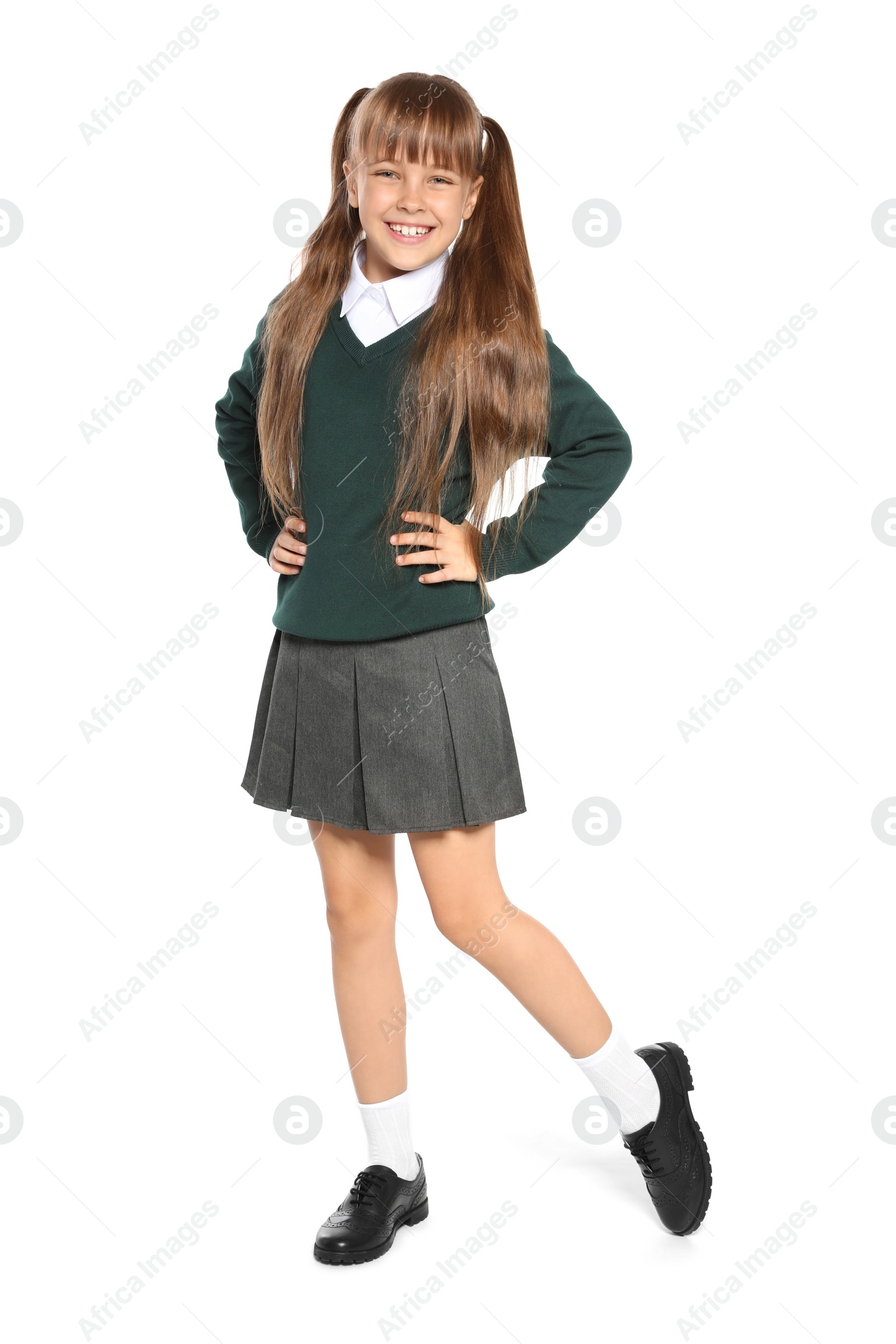 Photo of Little girl in stylish school uniform on white background