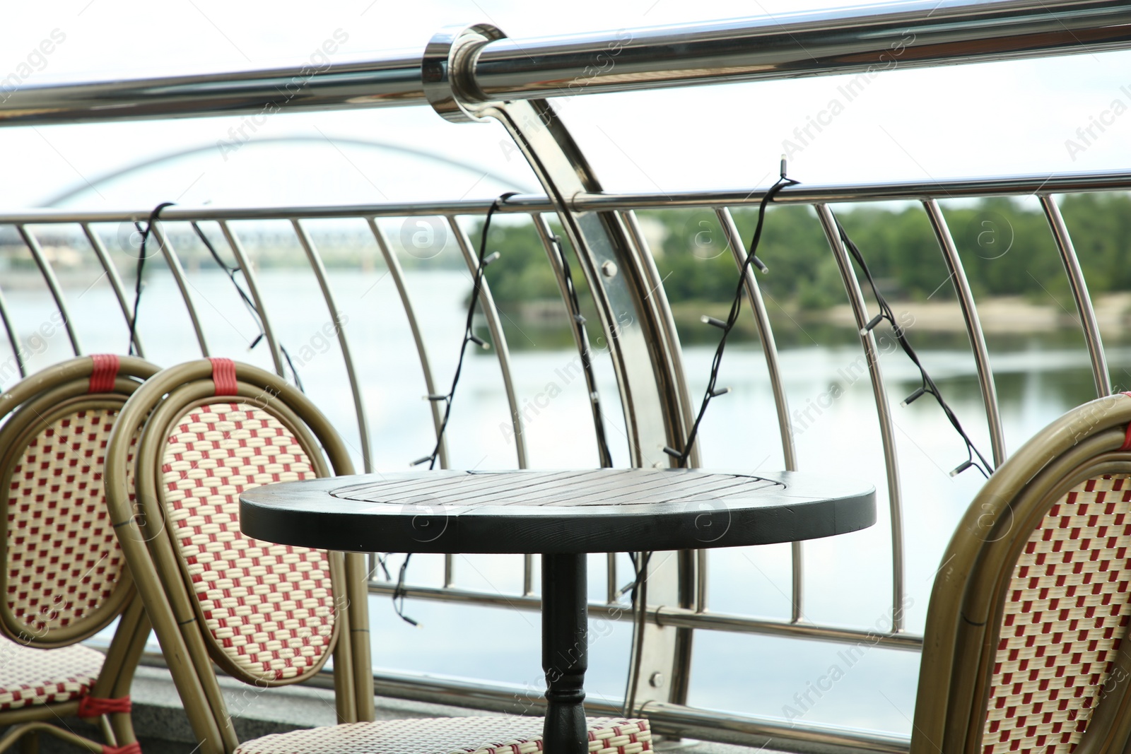 Photo of Stylish chairs and table on cafe terrace