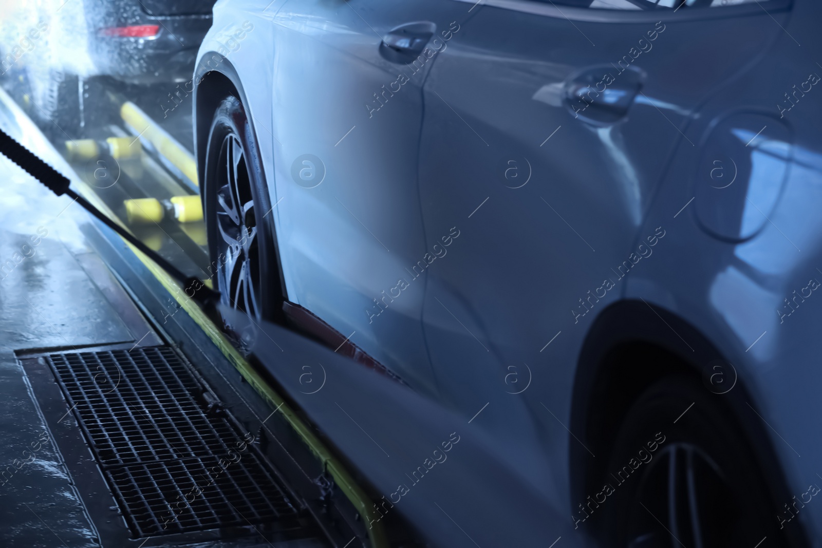 Photo of Cleaning auto with high pressure water jet at car wash