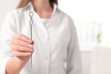 Photo of Speech therapist with logopedic probe in clinic, closeup. Space for text