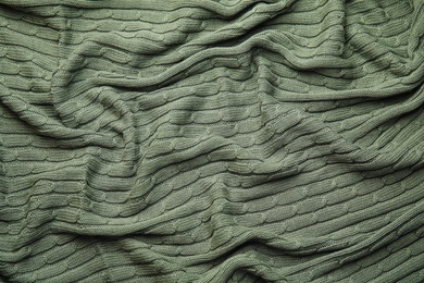 Photo of Soft knitted plaid as background, top view