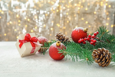 Photo of Beautiful Christmas composition with festive decor and gift box on table