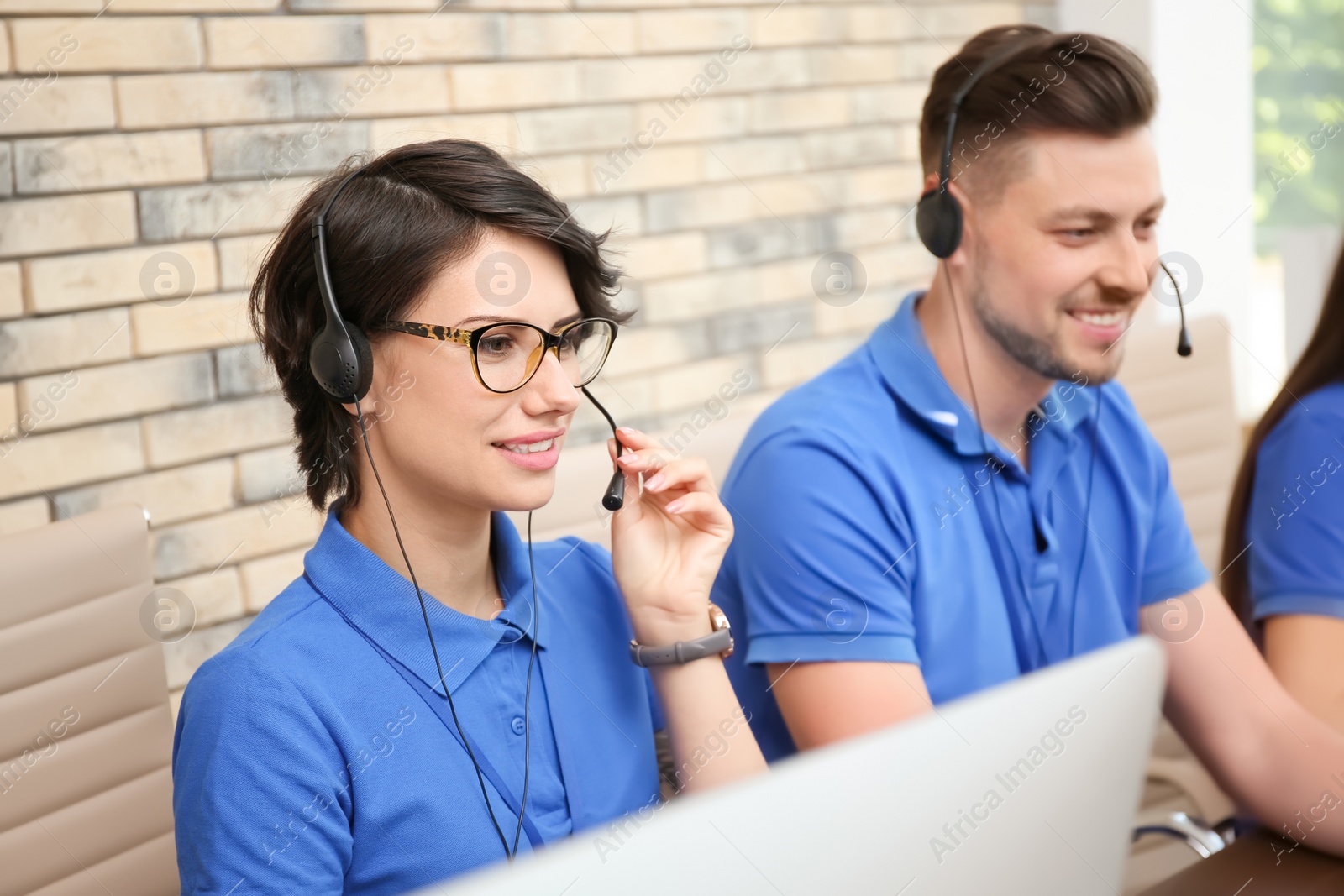 Photo of Technical support operators with headsets at workplace