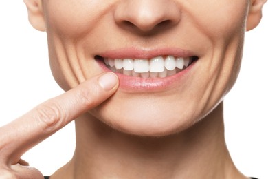 Woman showing healthy gums on white background, closeup