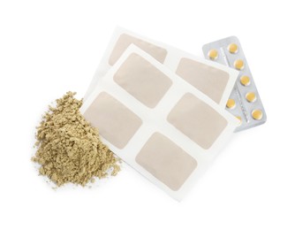 Mustard powder, plasters and pills on white background, top view