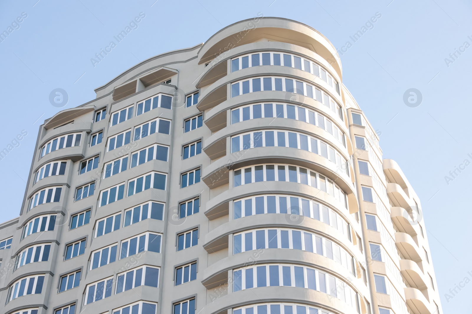 Photo of Modern building against blue sky, low angle view