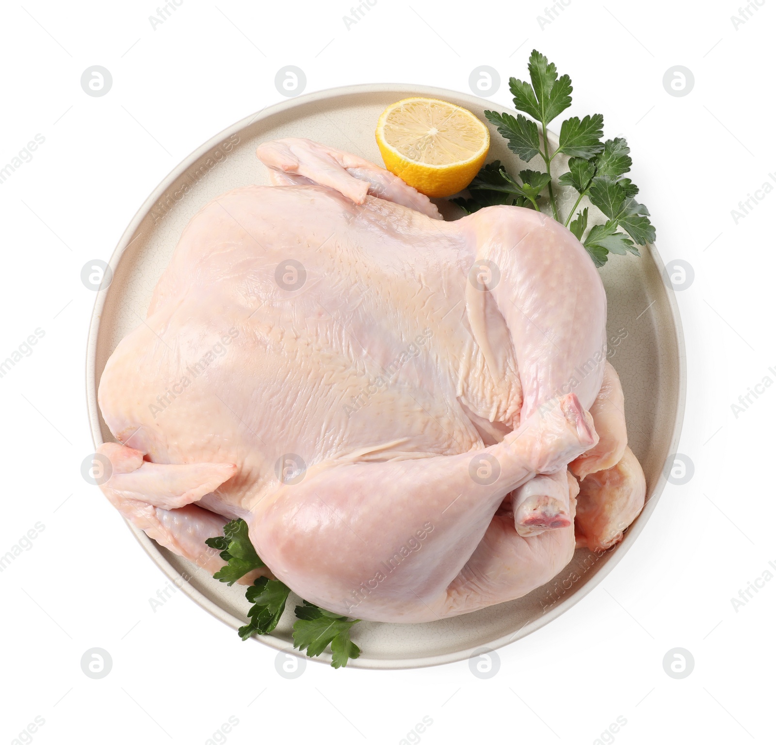 Photo of Fresh raw chicken with lemon and parsley isolated on white, top view