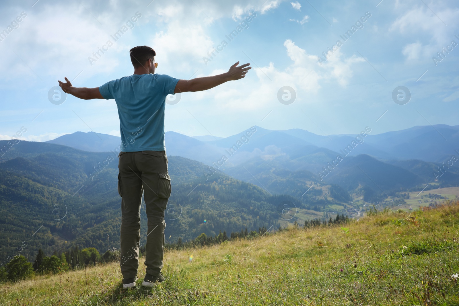 Photo of Happy tourist in mountains on sunny day