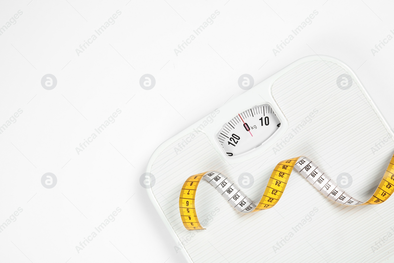 Photo of Modern scales and tape measure isolated on white, top view