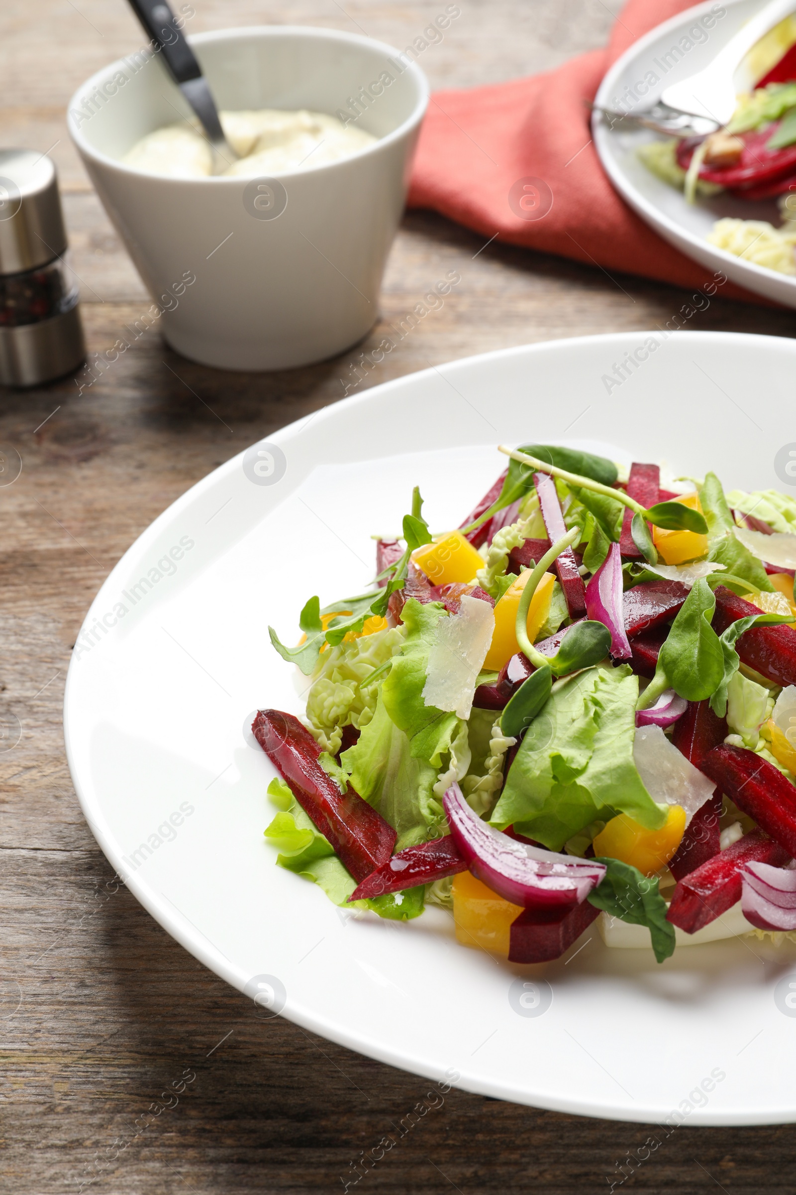 Photo of Plate with delicious beet salad on table, closeup