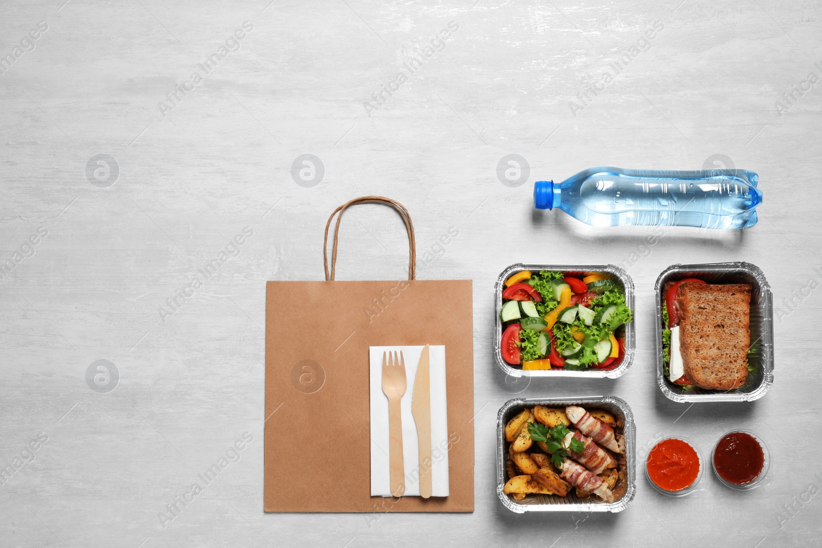 Photo of Lunchboxes on white wooden table, flat lay. Healthy food delivery