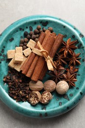 Photo of Different aromatic spices on light table, top view
