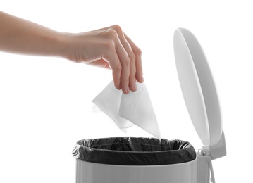 Photo of Woman putting paper tissue into trash bin on white background, closeup