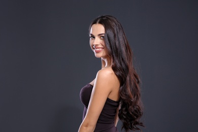 Portrait of beautiful model with gorgeous curly hair on black background