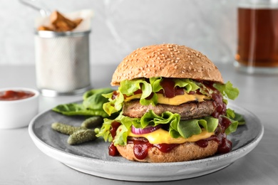 Photo of Plate with tasty burger on table. Space for text