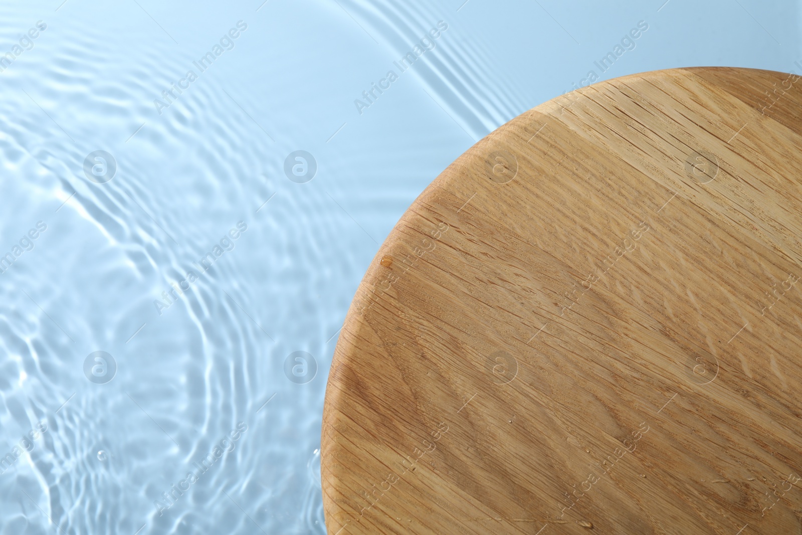 Photo of Wooden surface on light blue background, top view. Space for text