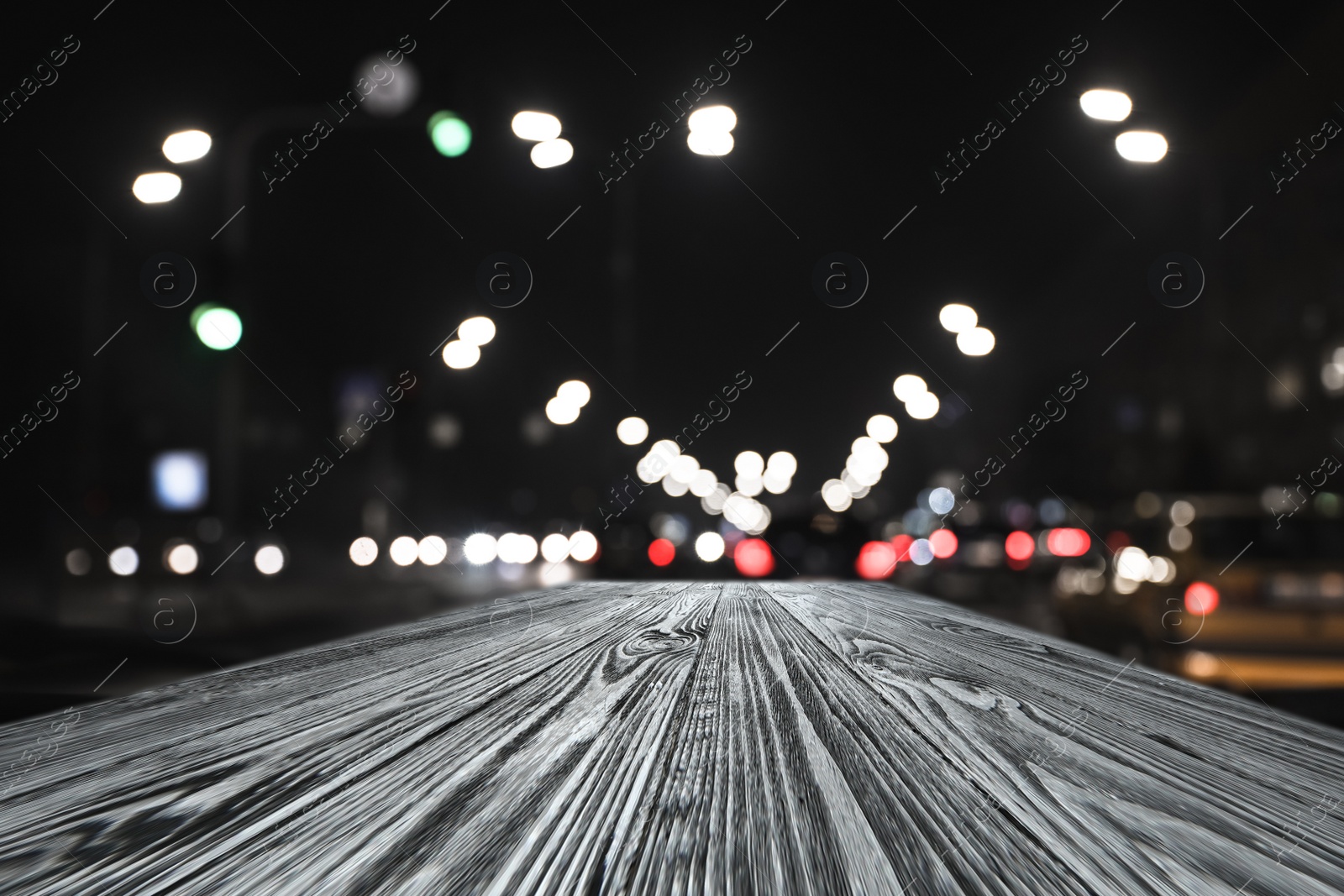 Image of Empty wooden surface and blurred view of night city