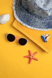 Flat lay composition with beach accessories on orange background