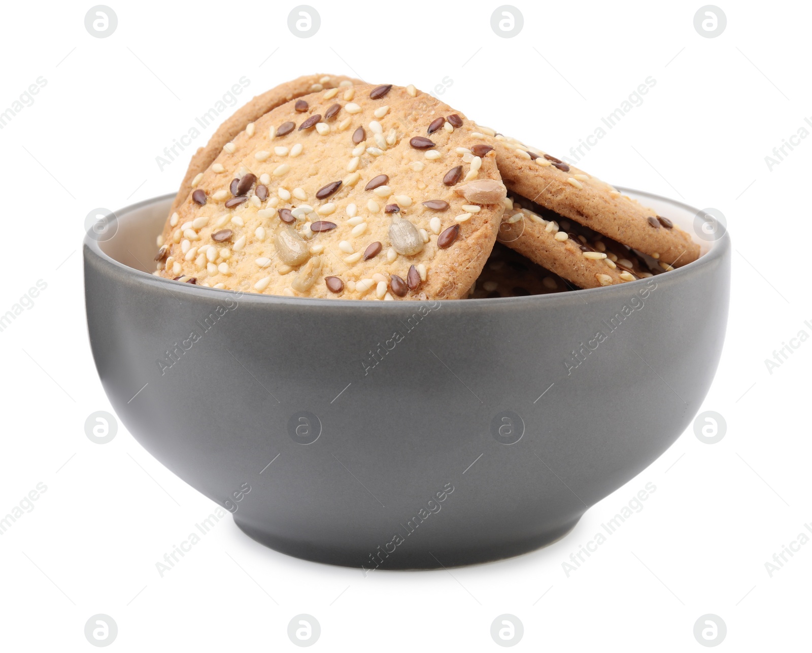 Photo of Round cereal crackers with flax, sunflower and sesame seeds in bowl isolated on white