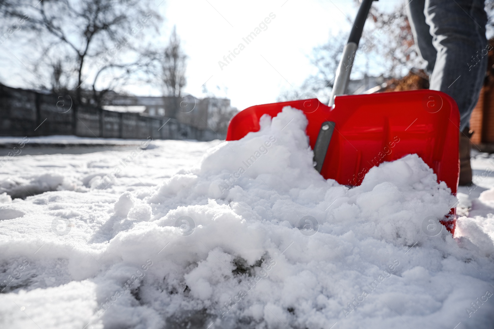 Photo of Person shoveling snow outdoors on winter day, closeup