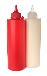 Photo of Plastic bottles of tasty mayonnaise and ketchup on white background