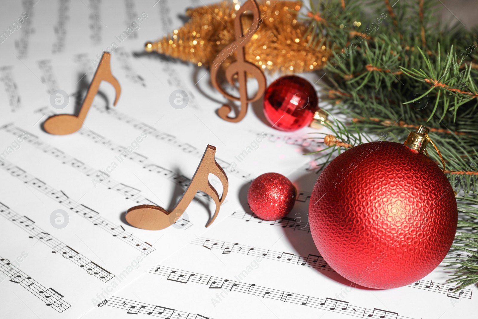 Photo of Composition with Christmas balls and wooden music notes on sheets