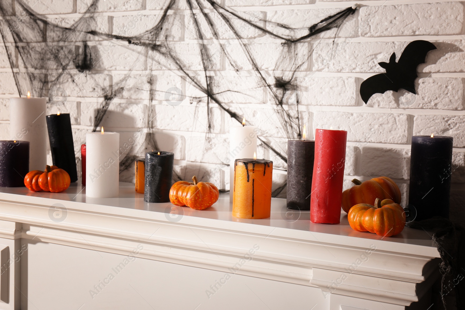 Photo of Fireplace with different Halloween decor indoors. Festive interior