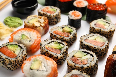 Set of delicious sushi rolls on white background, closeup