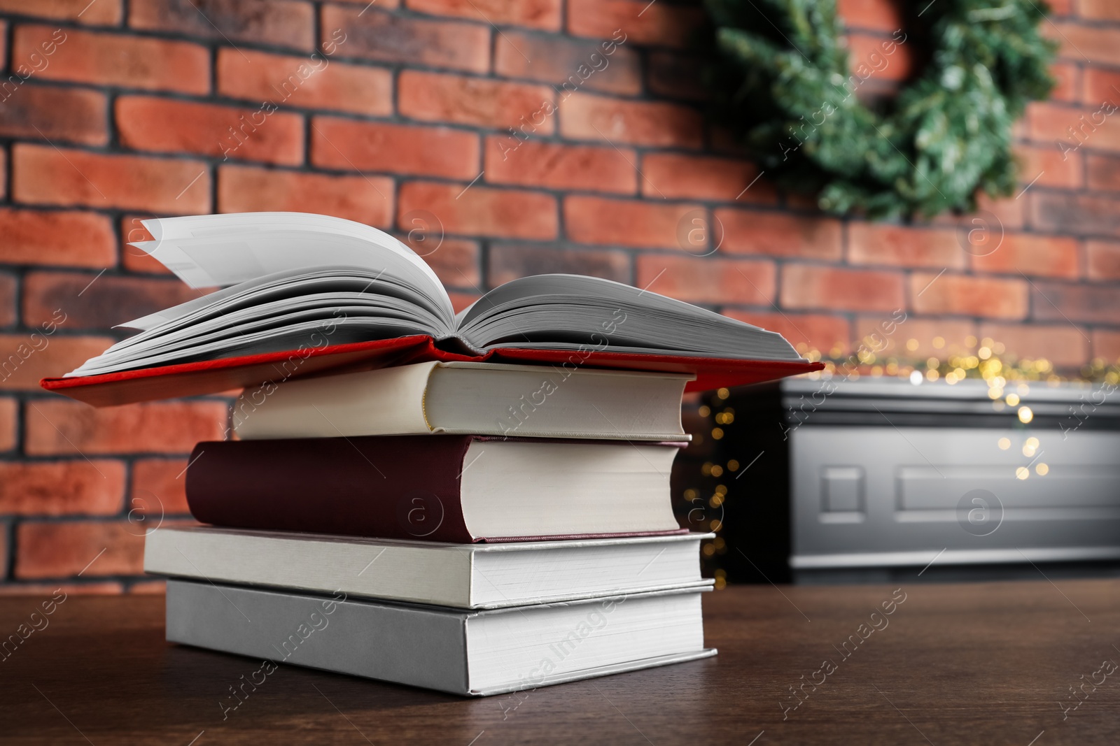 Photo of Stack of hardcover books on wooden table indoors