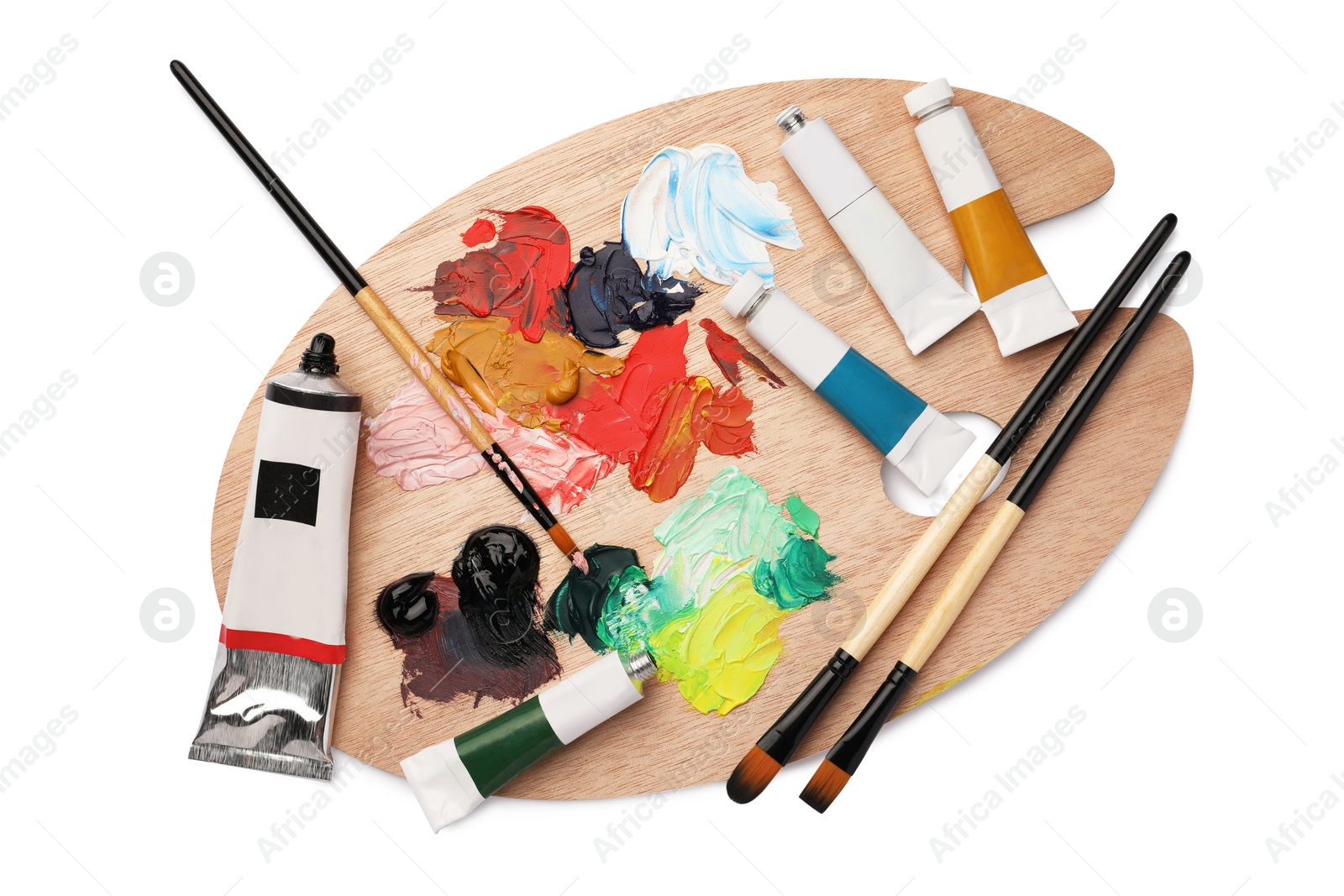 Photo of Wooden palette with oil paints and brushes on white background, top view