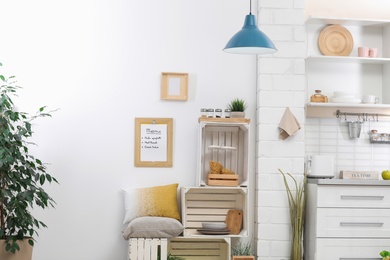 Photo of Modern kitchen interior with wooden crates as eco furniture