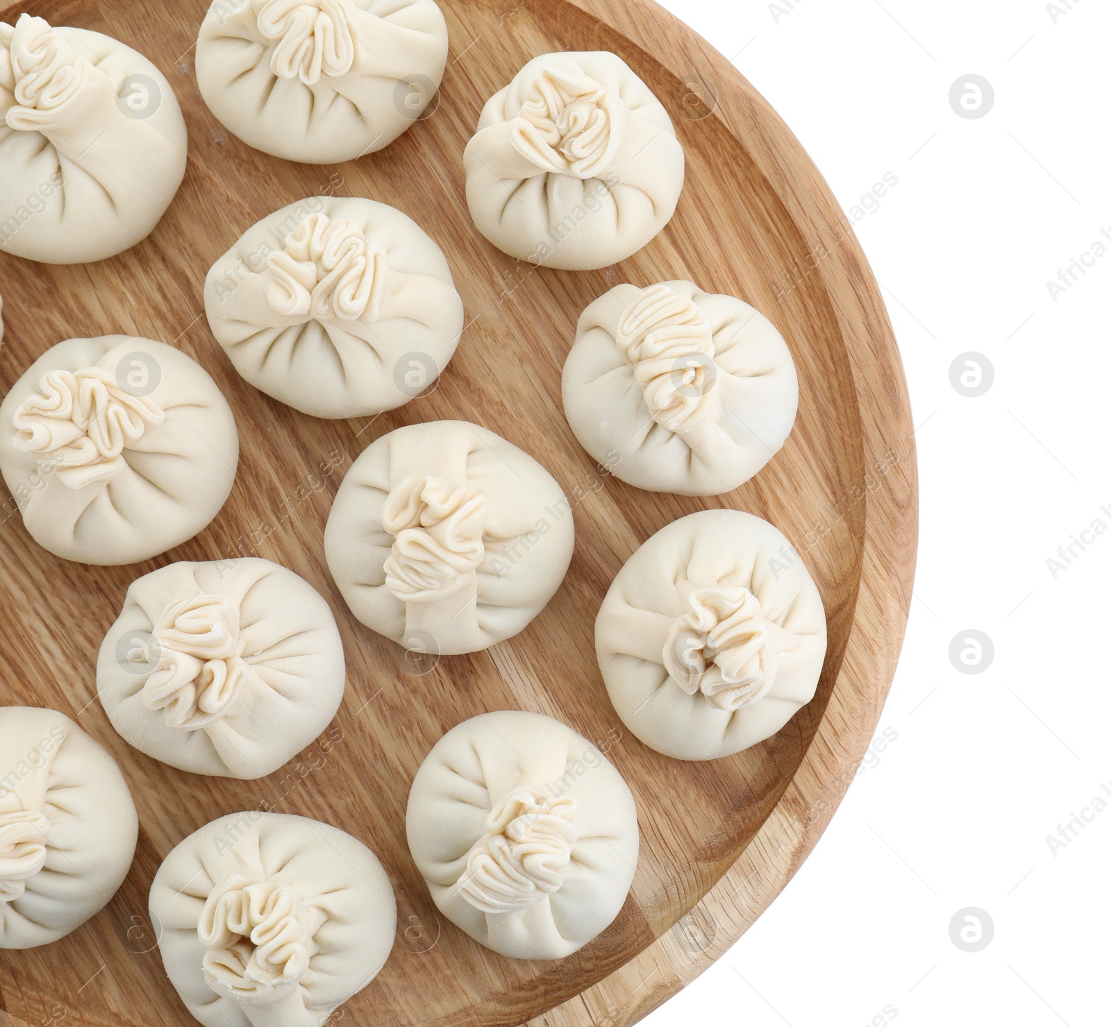 Photo of Board with uncooked khinkali (dumplings) isolated on white, top view. Georgian cuisine