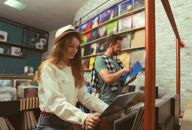 Image of Young people choosing vinyl records in store