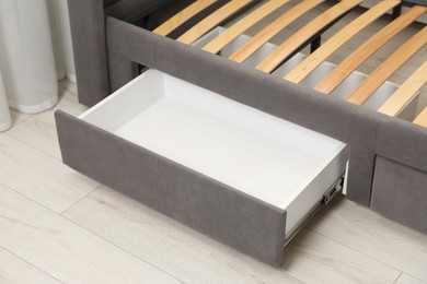 Storage drawer for bedding under modern bed in room