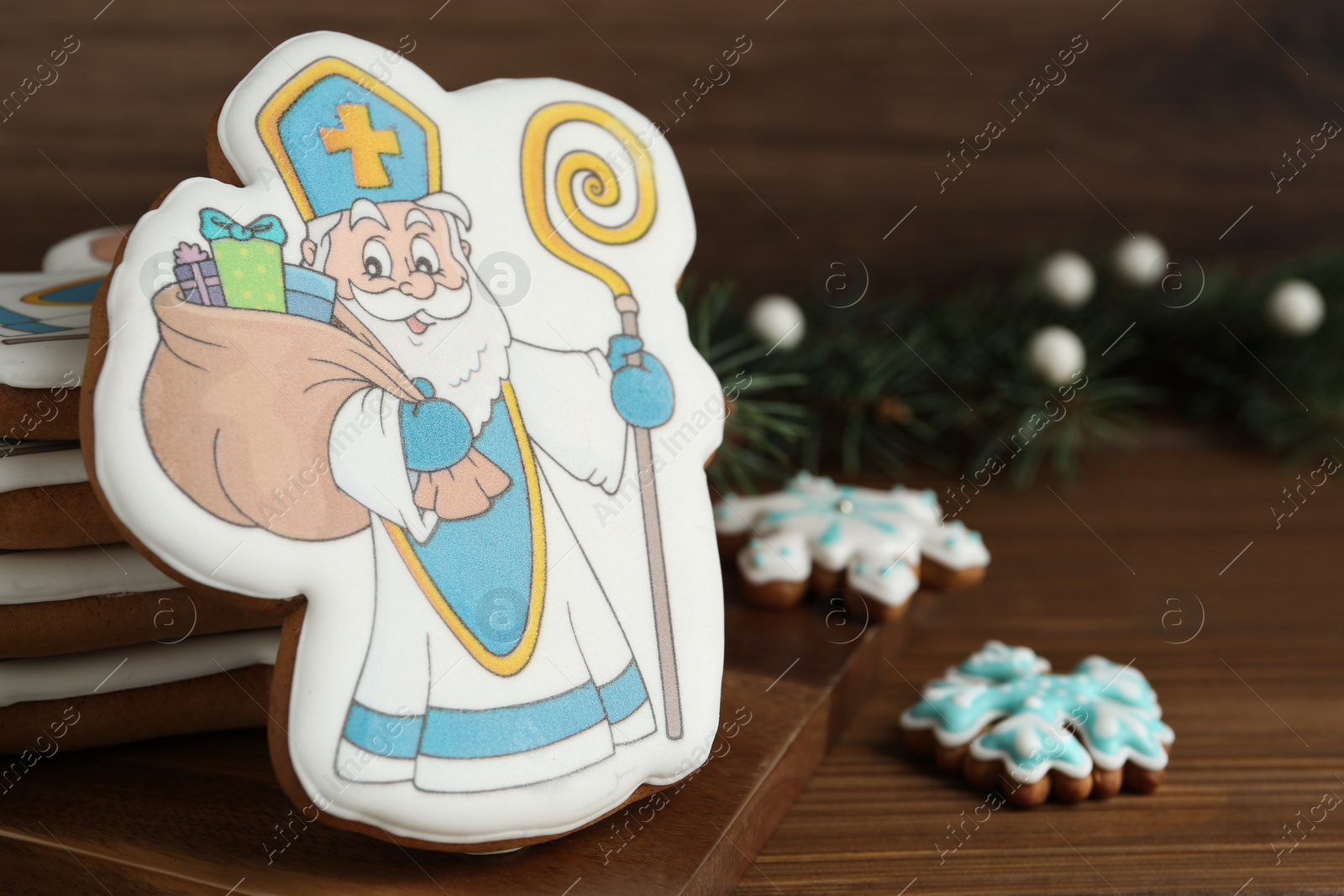Photo of Delicious gingerbread cookies on wooden table, closeup. Happy St. Nicholas Day