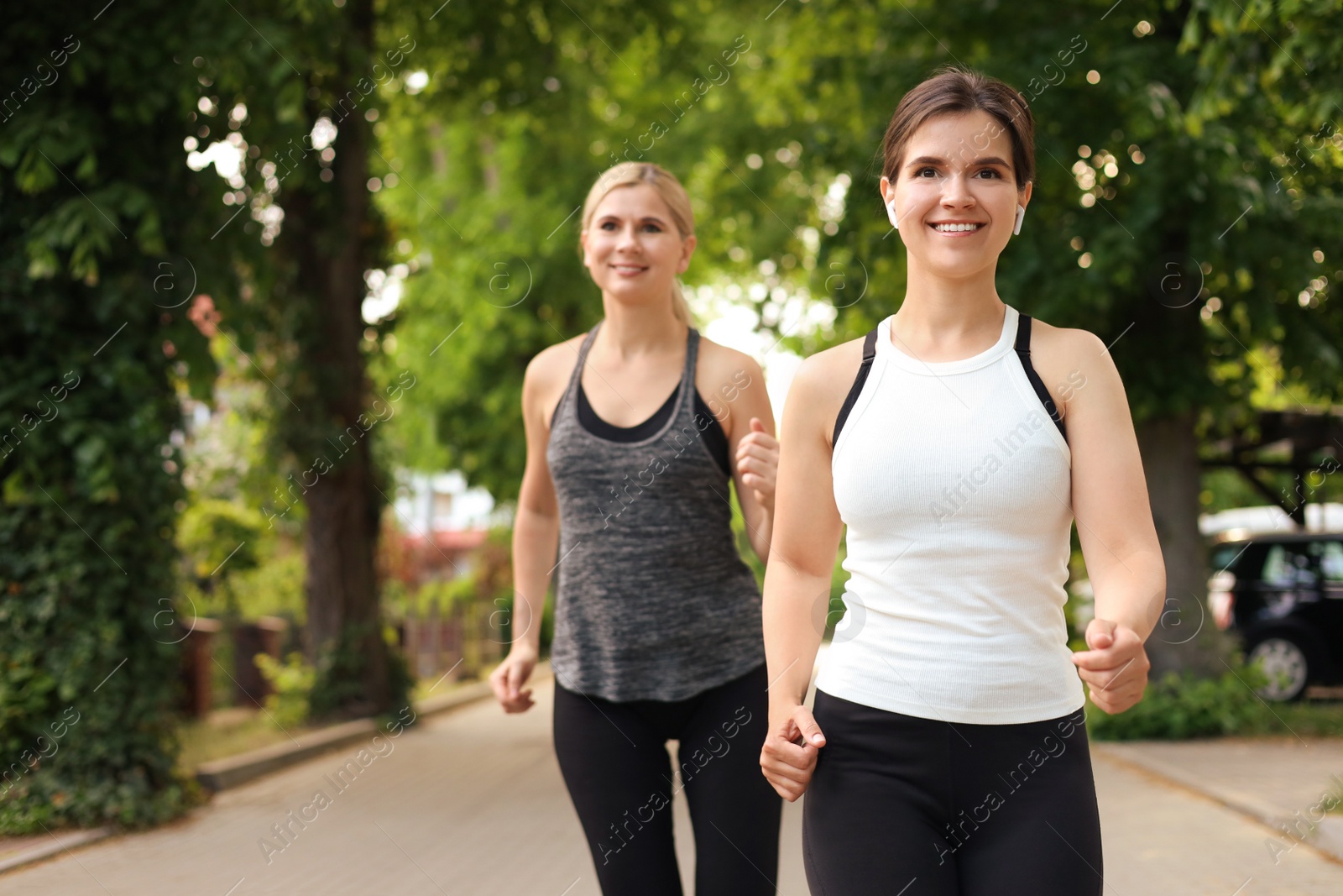 Photo of Women running on city street in morning