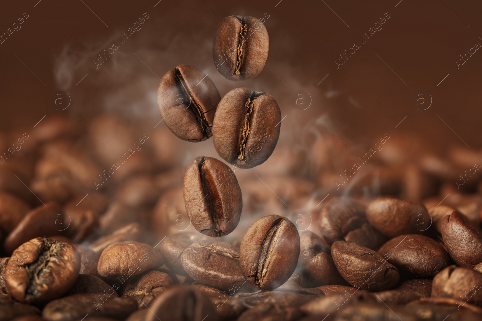 Image of Aromatic roasted coffee beans and steam, closeup