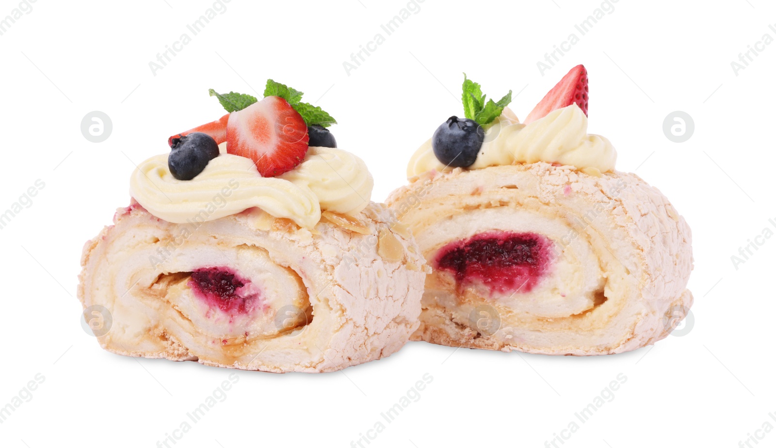 Photo of Slices of tasty meringue roll with jam, berries and mint leaves isolated on white