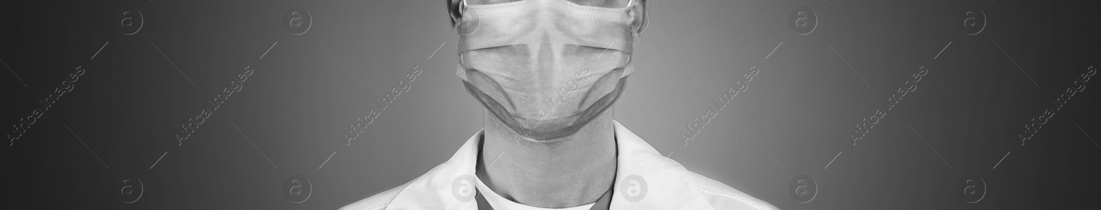 Image of Closeup view of man wearing medical face mask on grey background, banner design. Black and white photography