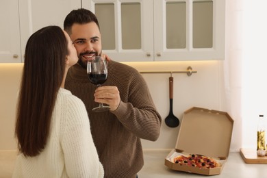 Happy young couple spending time together in kitchen