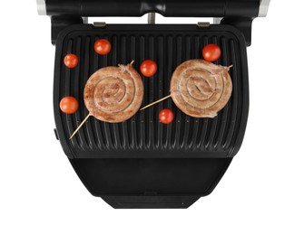 Photo of Electric grill with homemade sausages and fresh tomatoes isolated on white, top view