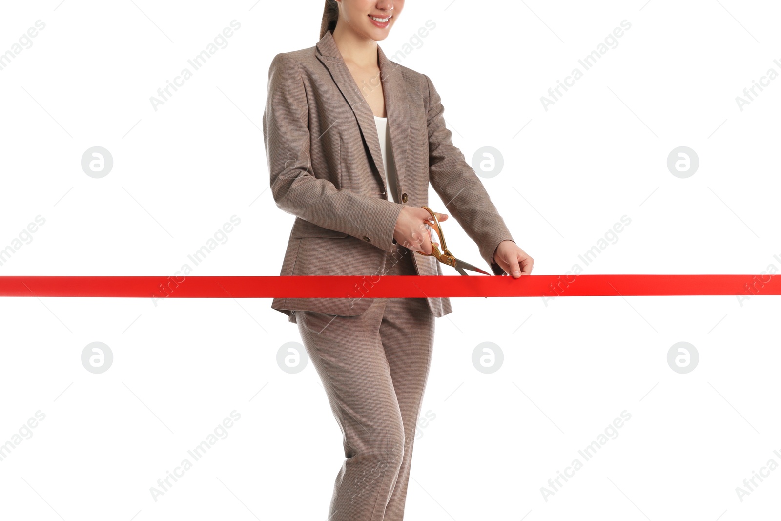 Photo of Woman in office suit cutting red ribbon isolated on white, closeup