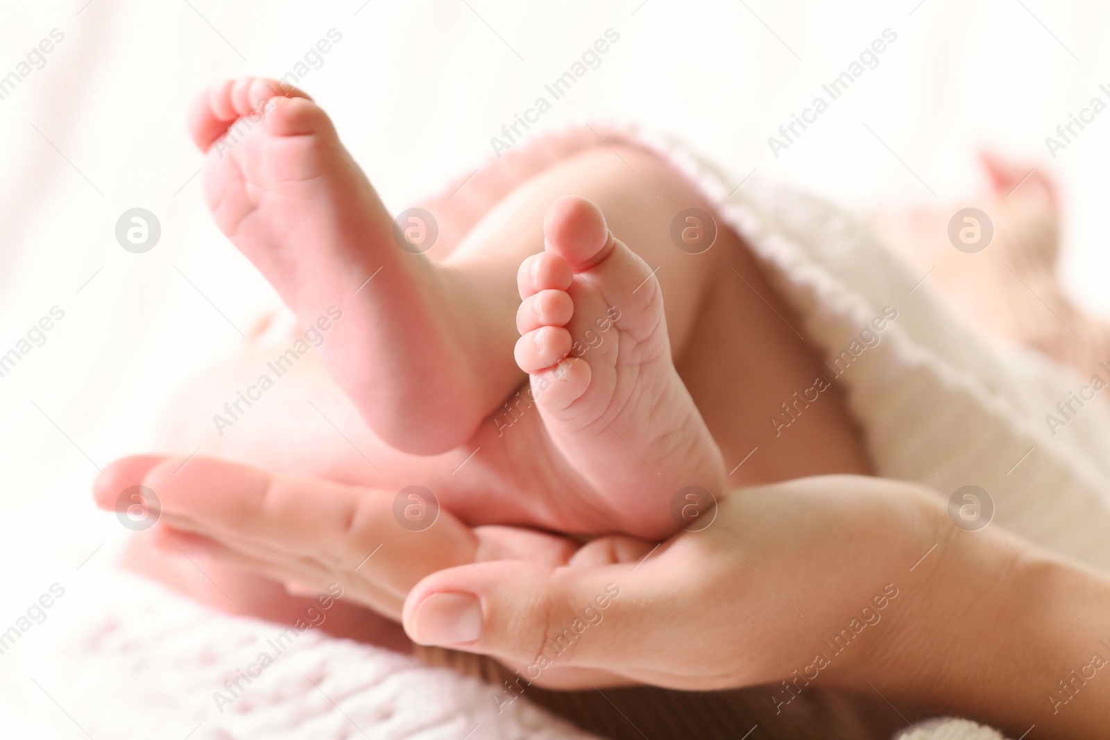 Photo of Mother and her newborn baby on bed, closeup view