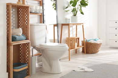 Photo of Interior of stylish bathroom with toilet bowl and decor elements