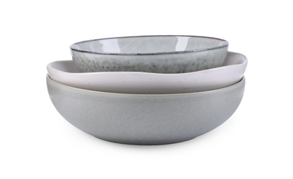 Clean empty ceramic bowls on white background